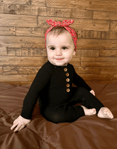 Little girl is wearing a soft baby headband for little girls from By Bella Boutique.